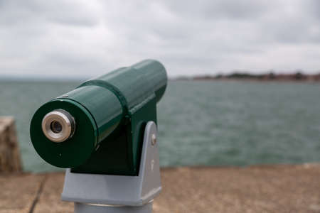 A pay per view telescope looking out to seaの写真素材
