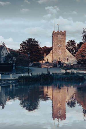 Buriton church in Hampshire reflecting on the village pondの写真素材