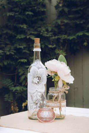 A Centre piece wine bottle on a vintage look wedding tableの写真素材