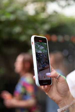 the screen of a mobile phone or cell phone whilst someone takes a videoの写真素材