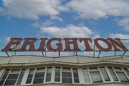 A sign reading Brighton with a blue sky and clouds in the backgroundのeditorial素材
