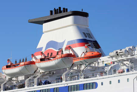 PORTSMOUTH, ENGLAND - MARCH 16 2016: Channel ferry lifeboats and tower against a blue sky.のeditorial素材