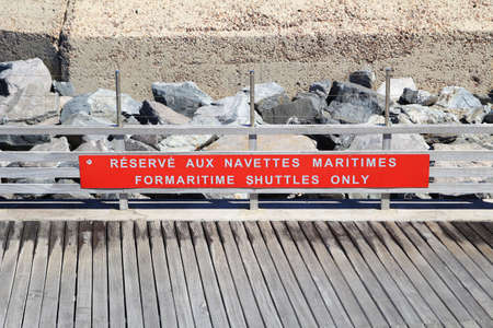 SAINT-TROPEZ, PROVENCE, FRANCE - AUGUST 21, 2016: Informational sign on the St Tropez jetty "FOR MARITIME SHUTTLES ONLY" (French translation "RÃÂ©servÃÂ© Aux Navettes Maritimes")のeditorial素材