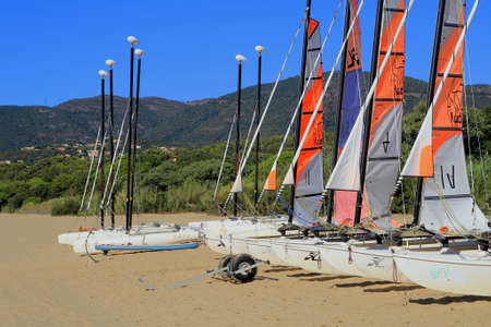 LA CROIX VALMER, PROVENCE, FRANCE - AUGUST 23 2016: Sailing dinghies from a yachting school in early morning sun on the beach at La Croix Valmer, on the French Rivieraのeditorial素材