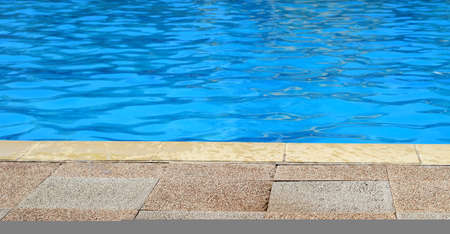 Edge of outdoor swimming pool for background with copy space