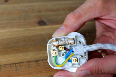 UK 13 amp domestic electric plug with back taken off to change the fuse