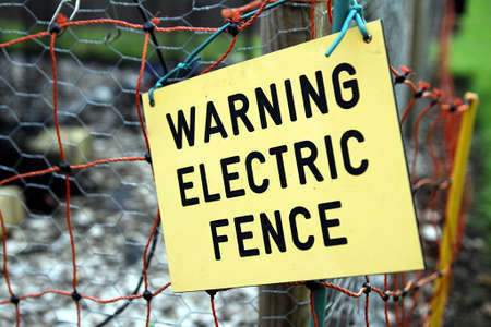 Warning electric fence sign on electric fence