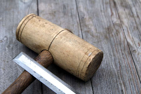 Wooden woodwork mallet and chisel on weathered wood backgroundの写真素材
