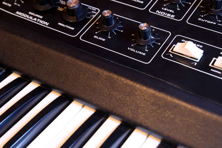 Closeup of keyboard and controls of a retro analogue synthesizerの写真素材