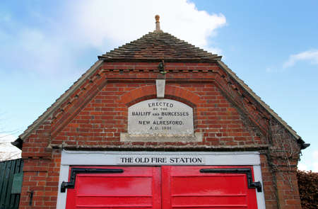 New Alresford, UK - Jan 28 2017 : The disused Old Fire Station in New Alresford, Hampshire UK. An old traditional Victorian red brick and tile building with red wooden doors.のeditorial素材