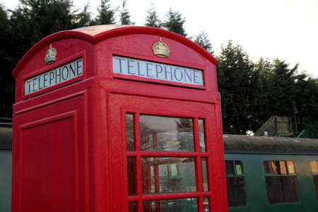 Alresford, UK - Jan 28 2017: Vintage British telephone box and railway carriages at Alresford Station, on the Watercress Line in Hampshire UKのeditorial素材