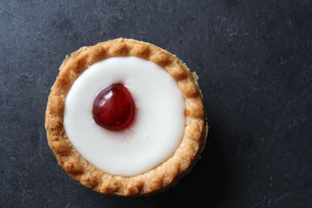 Cherry bakewell tart on dark backgroundの写真素材