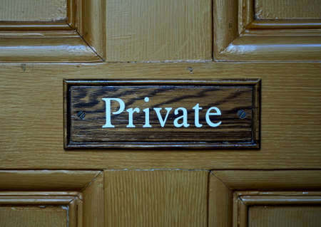 Wooden sign saying "Private", attached to abn old wooden doorの写真素材