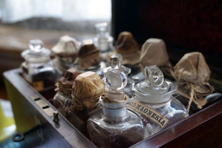 Old wooded case containing bottles and phials of medicine, including Magnesia