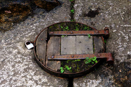 Old rustic wooden trap door with padlockの写真素材
