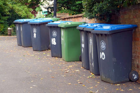 Stratford-upon-Avon, UK - July 21 2017: Row of wheelie bins for recycling and general waste ready to be emptiedのeditorial素材