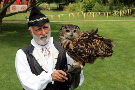 Stratford-upon-Avon, UK - July 23 2017: Falconer at Mary Arden's Tudor Farm with his Eagle Owlのeditorial素材