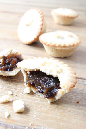 Selection of several mince pies, some broken open or partly eaten. A traditional festive Christmas dessert or pudding. Copy space for text.の写真素材