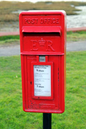 Bosham, Sussex, UK - Feb 15th 2017: Traditional red British Post Office "lamp" style letter boxのeditorial素材