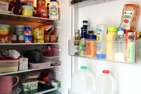 Camberley, UK - Feb 1st 2017: Contents of a packed domestic UK fridge or refrigerator, full of British supermarket food from Englandのeditorial素材