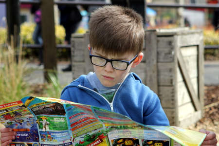 April 04 2016 - Windsor, UK: A young boy studies the map of the Legoland theme parkのeditorial素材
