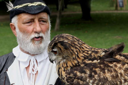 Stratford-upon-Avon, UK - July 22 2017: Falconer at Mary Arden's Tudor Farm with his Eagle Owlのeditorial素材