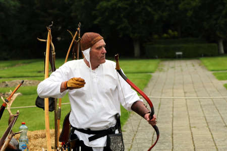 Beaulieu, Hampshire, UK - May 29 2017: Traditional archer with vintage bow demonstrating archeryのeditorial素材