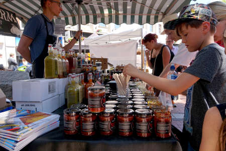 Reading, UK - June 17th 2017: Visitors to a chilli festival examining and trying samples of chilli sauces and spicy picklesのeditorial素材
