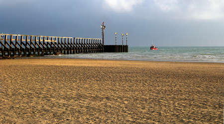 Littlehampton, Sussex, UK - October 25 2016: A small fishing boat returning to port in late afternoon sunshineのeditorial素材