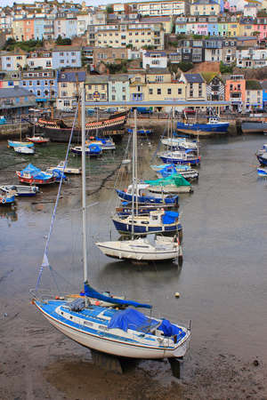 BRIXHAM, DEVON, UK, NOV 02 2015: Small boats moored at low tide in the fishing portのeditorial素材