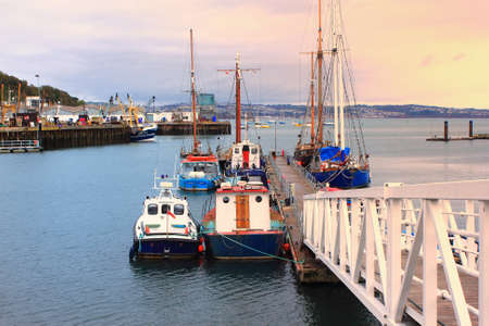BRIXHAM, DEVON, UK, NOV 02 2015: Small boats moored at a jetty in the harbourのeditorial素材