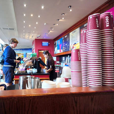Dover, England - August 18 2017: A Costa barista serves a customerのeditorial素材