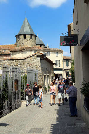 Carcassonne, Languedoc-Roussillon, France - August 24 2017: Tourists enjoying the sunshine along a cobbled street in the medieval French fortified city of Carcassonne, La Cite, Languedoc-Roussillon, Francexのeditorial素材