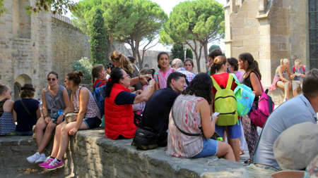 Carcassonne, Languedoc-Roussillon, France - August 24 2017: Large group of young people gathered outside the Basilique Saint Nazaire, in the medieval French fortified city of Carcassonne, La Cite, Languedoc-Roussillon, Franceのeditorial素材