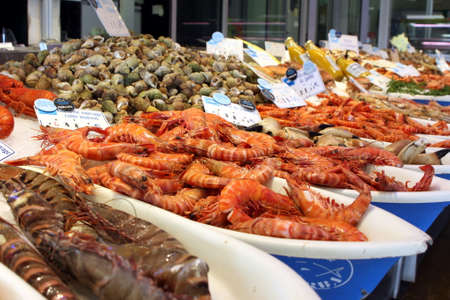 Valras-Plage, Herault, France - Aug 25 2017: Selection of raw and cooked shrimp, prawn, crab and other shellfish for sale in a French seafood storeのeditorial素材