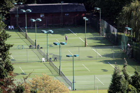 Warwick, UK - September 17 2017: Aerial view of public tennis and sports courts and pitches, with a man playing tennisのeditorial素材