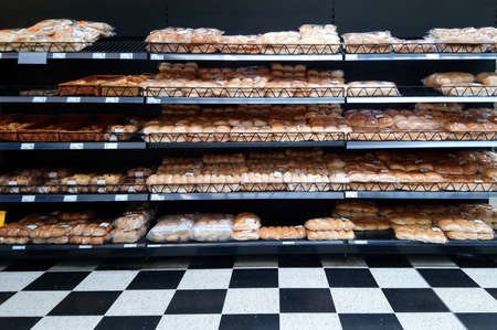 Basingstoke, UK - August 7 2017: Rows of bread and other baked products on shelves at the instore bakery of a major grocery superstoreのeditorial素材