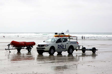 Perranporth, Cornwall, UK - April 9 2018: Truck and dinghy belonging to the RNLI Lifeguard with surf...