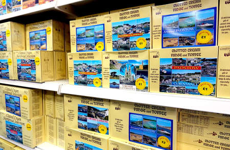 Padstow, Cornwall, April 11th 2018: Boxes of souvenir clotted cream fudge and toffee for sale in a...