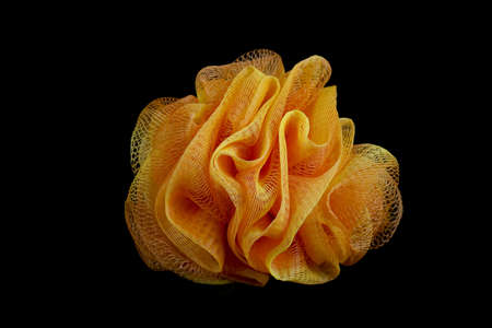 Orange Bath Sponge Black Backgroundの写真素材