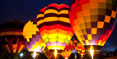 A number of Hot Air Balloons fire their burners lighting up the entire balloon. Carolinas Balloon Festival, Statesville, North Carolina.の写真素材