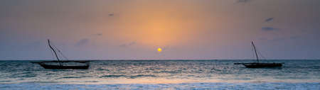 The morning sun as it peeks over the easern horizon. Zanzibar, Tanzaniaの写真素材