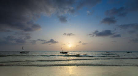 The morning sun as it peeks over the easern horizon. Zanzibar, Tanzaniaの写真素材