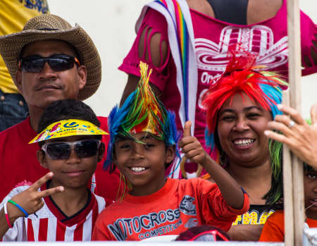 Barranquilla, Colombia - March 1, 2014 a family wears funny hats and smiles for the camera as they watch the Barranquilla carnival.のeditorial素材