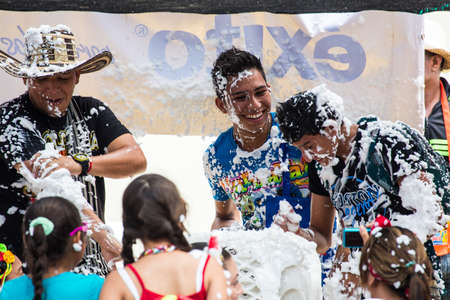 Barranquilla, Colombia - March 1, 2014 - Families and friends battle with white foam in the stands of the Barranquilla Carnival. The foam is basically soap and water sprayed from an arosol can.のeditorial素材