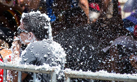Barranquilla, Colombia - March 1, 2014 - Families and friends battle with white foam in the stands of the Barranquilla Carnival. The foam is basically soap and water sprayed from an arosol can.のeditorial素材