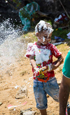 Barranquilla, Colombia - March 1, 2014 - Families and friends battle with white foam in the stands of the Barranquilla Carnival. The foam is basically soap and water sprayed from an arosol can.のeditorial素材