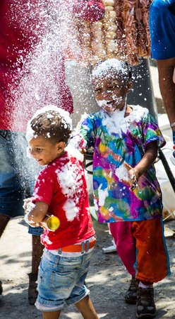 Barranquilla, Colombia - March 1, 2014 - Families and friends battle with white foam in the stands of the Barranquilla Carnival. The foam is basically soap and water sprayed from an arosol can.のeditorial素材