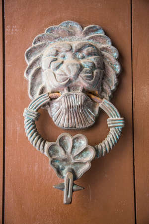 Ornate door knockers and detail on th famous doors of Cartagena's historic old city.の写真素材
