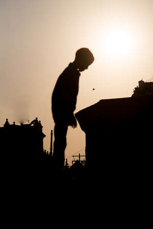 Cartagena, Colombia - February 23, 2014 - A young boy stands atop an old historic cannon as his father offers a hand down.の写真素材